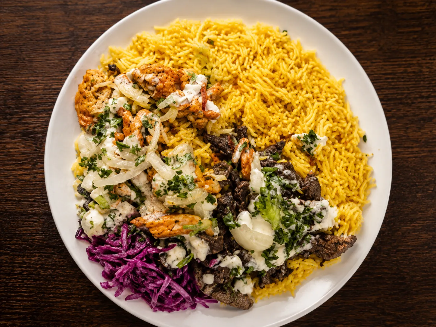 Grilled kebab platter with fresh herbs at King's Restaurant, Manitoba's Middle Eastern shawarma restaurant